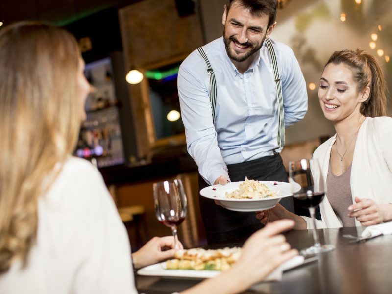 The waiter carries dishes